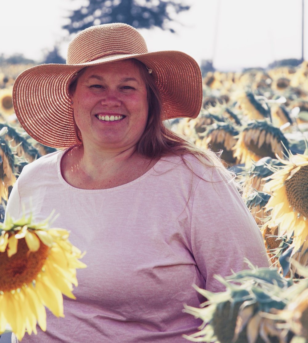 Portrait of Emily Hinkle in a sunflower field